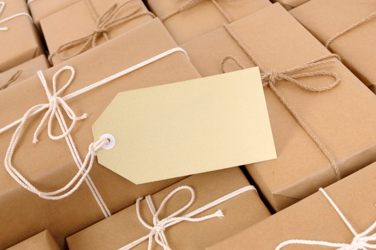 Blank label tag tied to brown paper parcels, standing in for the frozen Shopify additional scripts field